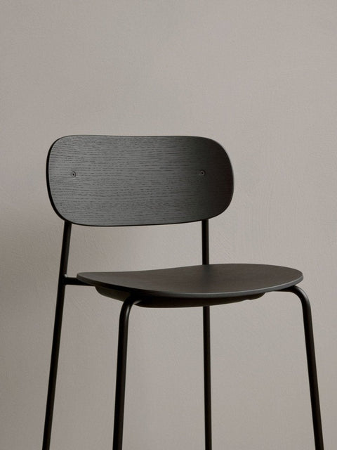 Audo Copenhagen Co Bar Chair, Non-Upholstered, close-up of the Co Bar Chair in black oak veneer, showing the detail of the wood grain on the backrest and seat