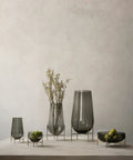 smoked glass echasse vase by theresa rand on a brushed brass metal base by audo copenhagen