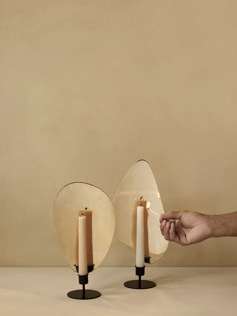 table top candle holder finished in brass with an organic shape by audo copenhagen