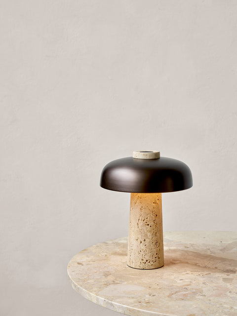 scandinavian reverse table lamp with travertine and brushed brass designed by Aleksandar Lazic for audo copenhagen