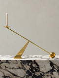 brass geometric candleholder on marble plinth coffee table