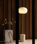 jwda travertine wall lamp and marble plinth end table by audo copenhagen