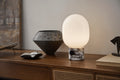 marble table lamp by audo copenhagen on walnut sideboard