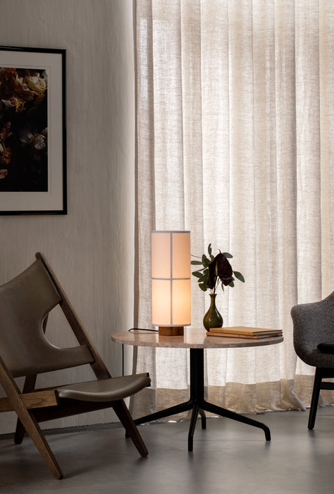 Knitting Lounge Chair in brown oak with leather upholstery beside Harbour Column Table and Hashira Table Lamp.