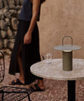 portable table lamp in dusty green by audo copenhagen