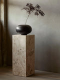 wooden vase on a marble plinth pedestal by audo copenhagen