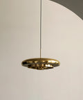 resonant ceiling light fixture in brushed brass designed by Alf Svensson & Yngvar Sandström for audo copenhagen