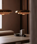 resonant ceiling light fixture in brushed brass designed by Alf Svensson & Yngvar Sandström for audo copenhagen