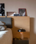 scandinavian inspired bedroom with scandinavian reverse table lamp with travertine and brushed brass designed by Aleksandar Lazic for audo copenhagen