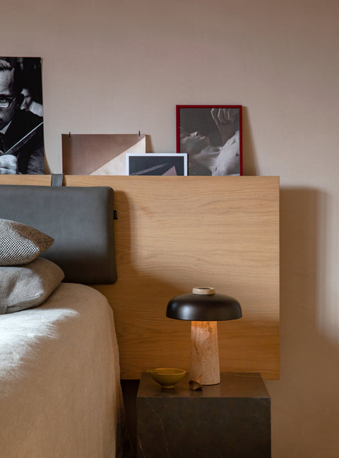 scandinavian inspired bedroom with scandinavian reverse table lamp with travertine and brushed brass designed by Aleksandar Lazic for audo copenhagen