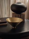 wooden vase and brass vase on a black end table