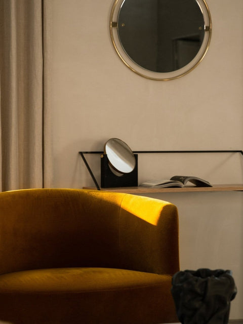 Audo Copenhagen Tearoom Chairs and Sofas, mustard yellow Tearoom Lounge Chair in a sunlit corner, with a Rail Desk, Pepe Marble Mirror, and Nimbus Mirror