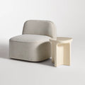 Small Talk Tall Side Table by Blu Dot in Ivory glass fiber reinforced concrete, styled with lounge chair, 3/4 view