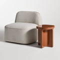 Small Talk Tall Side Table by Blu Dot in Rust glass fiber reinforced concrete, styled with lounge chair, 3/4 view