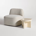 Small Talk Side Table by Blu Dot in Ivory glass fiber reinforced concrete, styled with lounge chair, 3/4 view