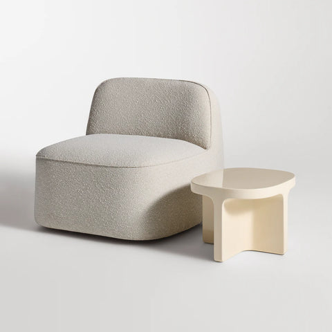 Small Talk Side Table by Blu Dot in Ivory glass fiber reinforced concrete, styled with lounge chair, 3/4 view