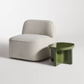 Small Talk Side Table by Blu Dot in Olive glass fiber reinforced concrete, styled with lounge chair, 3/4 view