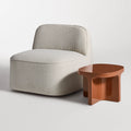 Small Talk Side Table by Blu Dot in Rust glass fiber reinforced concrete, styled with lounge chair, 3/4 view