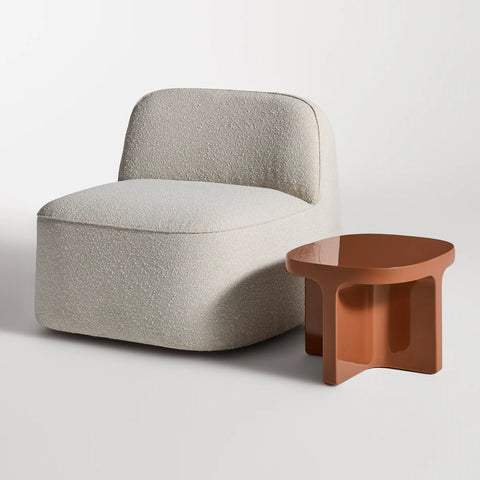 Small Talk Side Table by Blu Dot in Rust glass fiber reinforced concrete, styled with lounge chair, 3/4 view