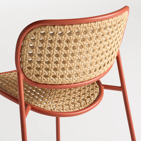 Made You Look Outdoor Chair by Blu Dot, woven plastic rattan back and seat detail, Tomato frame