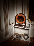 Museum Trolley by String Furniture in white used as a dressing table with a mirror, jewellery and watches in a classic panelled room