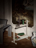 Museum Trolley by TAF Studio for String Furniture in white, styled with a candle holder, table lamp, books and magazines