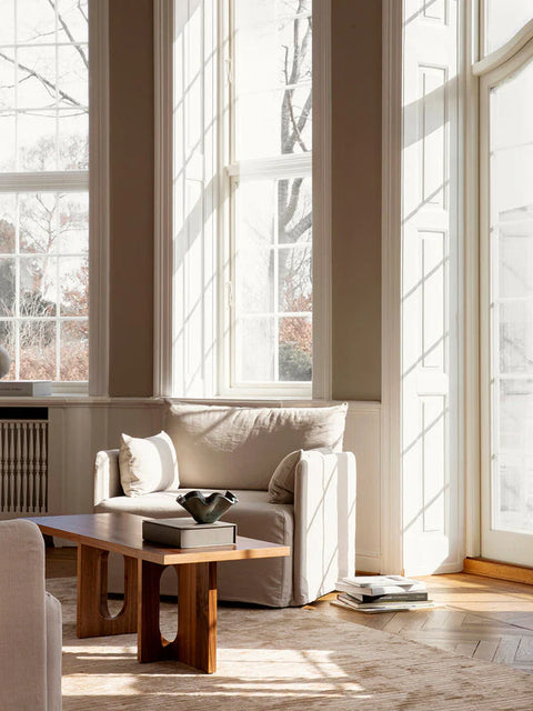 scandinavian living room with big windows and high ceilings featuring furniture by audo copenhagen