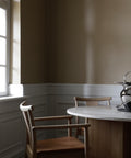 natural oak merkur dining chair with arms and dakar leather seat designed by Skogstad & Wærnes for audo copenhagen