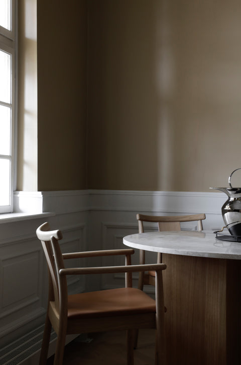 natural oak merkur dining chair with arms and dakar leather seat designed by Skogstad & Wærnes for audo copenhagen