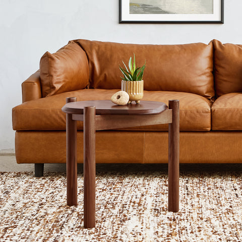 modern walnut end table and cognac leather sofa by canadian furniture company gus modern