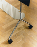Pedestal Moon Light Shelf in Chrome, steel shelf for the Moon Light TV stand, close up of the chrome legs and wheels on a wooden floor