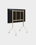 Pedestal Moon Tall TV Stand in Oat, seen from behind with a screen fitted, on a plain background