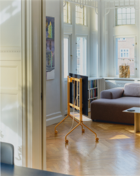 Pedestal Wheels in Apricot, replacement TV stand wheels, fitted to an Apricot stand in a room with a sofa