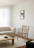 Minimal living room with light beige Nami Sofa Klint Chair in oak and Islets coffee table