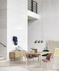 high ceiling scandinavian modern dining room interior with furniture and lighting from muuto