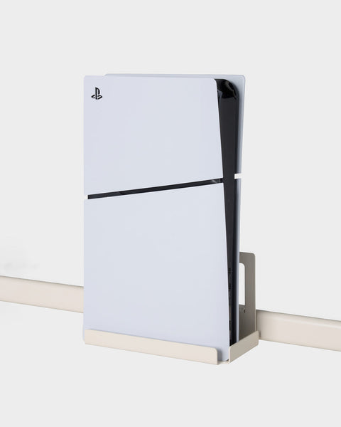 Pedestal PS5 Slim Mount in Pearl, steel console bracket, holding a PS5 Slim on the bar of a TV stand