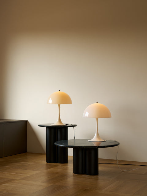 Pair of Panthella 320 Table Lamps by Louis Poulsen in opal white and opal beige on black marble side tables in a contemporary living room.