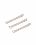 Pedestal Cable Tie in Oat, three silicone cable ties laid side by side, on a plain white background