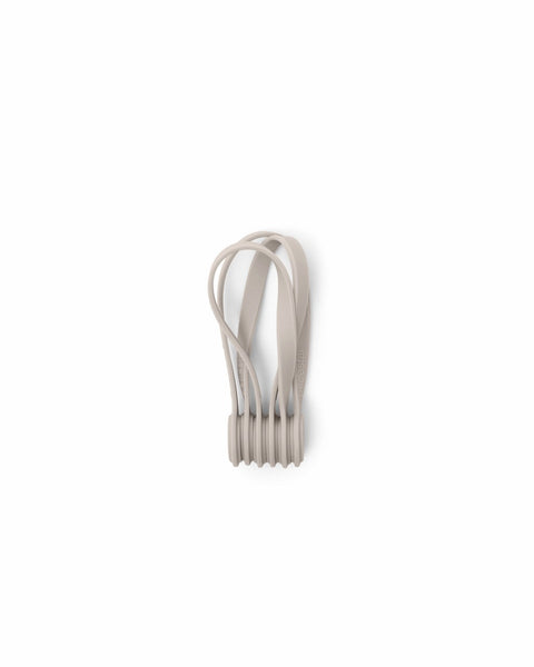 Pedestal Magnetic Cable Ties in Oat, three magnetic silicone cable ties, on a plain white background