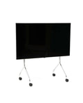 Pedestal Moon TV Stand in Chrome, rolling TV stand on wheels holding a flat screen TV, on a plain white background