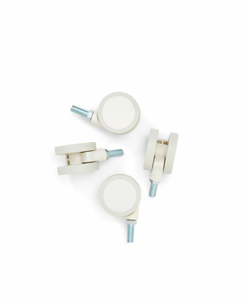 Pedestal Wheels in Pearl, set of four furniture wheels, on a plain white background