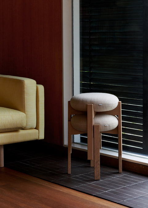 Stacked Pioneer Stools in oak by window in warm modern interior