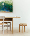 scandinavian dining room with stool and abstract artwork