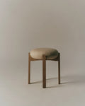 Pioneer Stool product shot, oak legs with textured beige upholstered seat