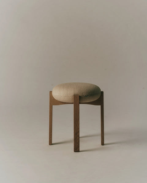 Pioneer Stool product shot, oak legs with textured beige upholstered seat