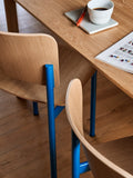 Minimalist and colourful dining chair with wood frame and backrest and blue frame