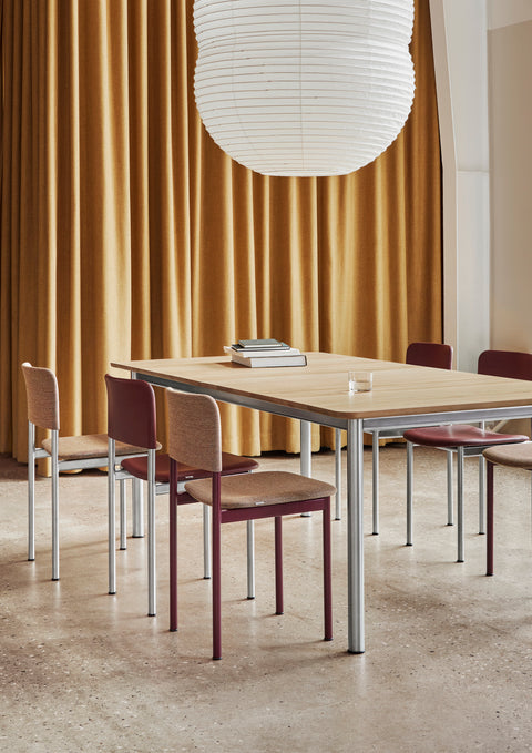 Fredericia Plan Chairs in Bordeaux red and brown upholstery with brushed chrome legs around rectangular wood table
