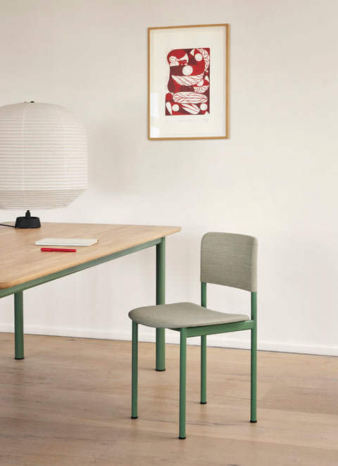 Fredericia Plan Chair with green frame and light grey upholstery beside rectangular oak dining table