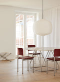 Fredericia Plan Chairs in Indian red leather with brushed chrome legs around round marble dining table