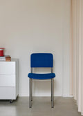 Fredericia Plan Chair in blue upholstery with brushed chrome legs placed in modern interior